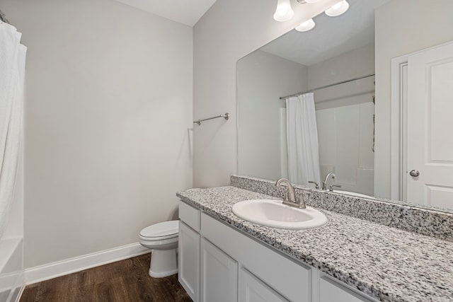 bathroom featuring toilet, vanity, and hardwood / wood-style floors