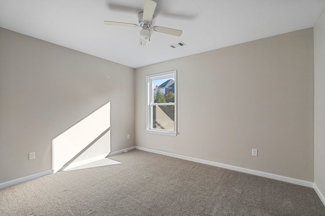 empty room with ceiling fan and carpet flooring