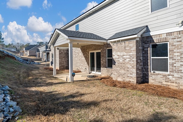 view of property exterior with a patio area and a yard