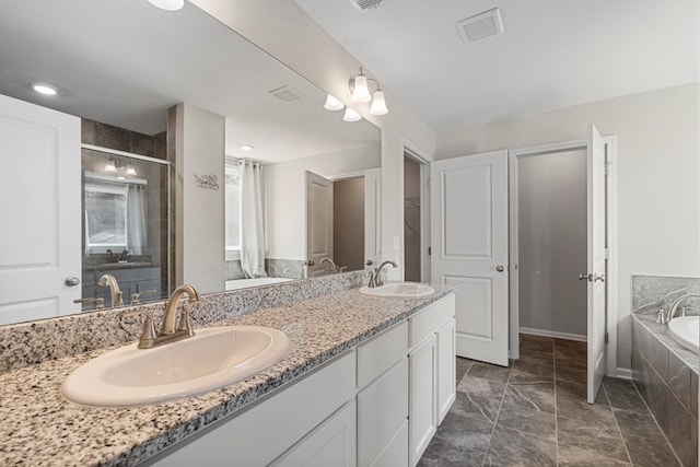 bathroom with independent shower and bath and vanity