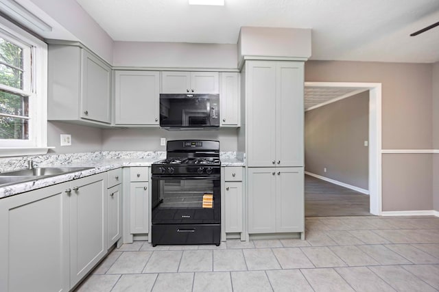 5906 Forrest Rd, Columbus, GA 31907 - kitchen featuring black appliances, light tile patterned floors, and ceiling fan