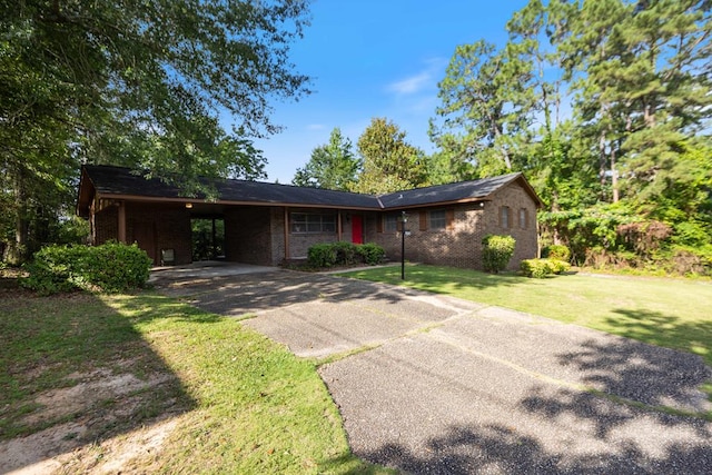5906 Forrest Rd, Columbus, GA 31907 - ranch-style house featuring driveway, a front yard, brick siding, and a carport