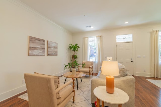 living room with crown molding and hardwood / wood-style flooring