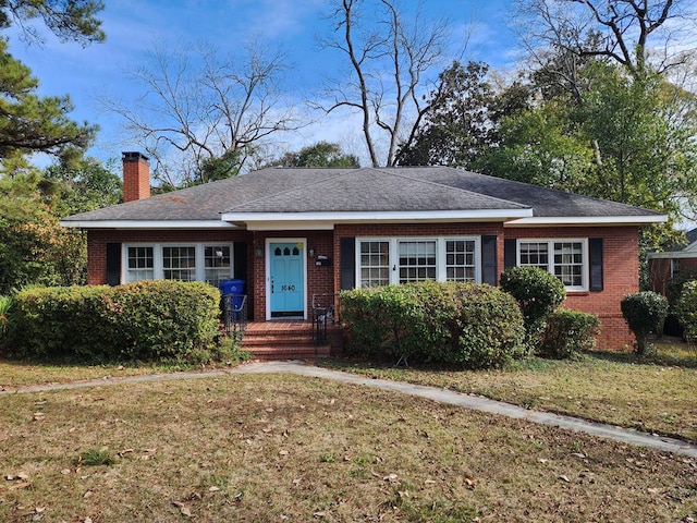 1640 Preston Dr, Columbus, GA 31906 - view of front of house with brick siding, a chimney, and a front yard