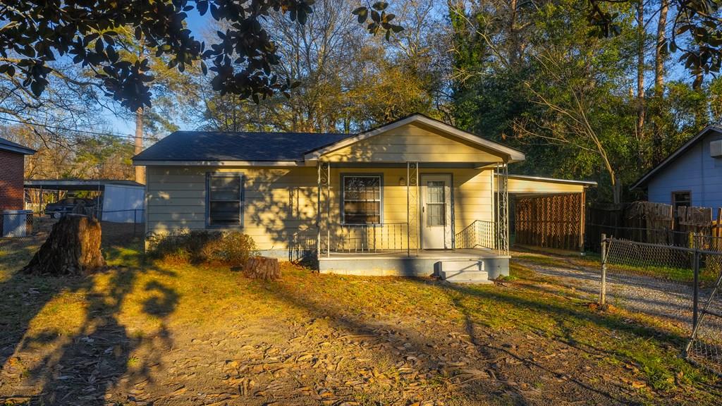 bungalow featuring a porch and a carport