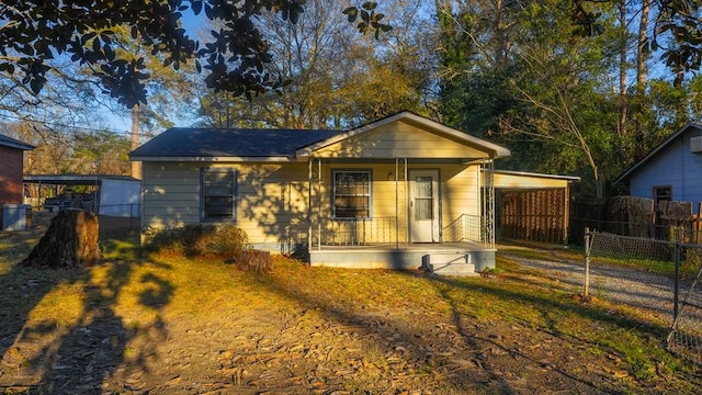 bungalow featuring a porch and a carport