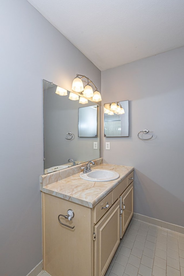 bathroom featuring tile patterned floors, vanity, and baseboards