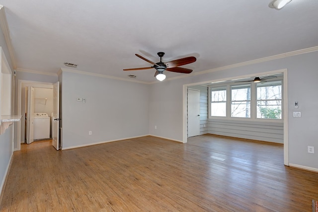 unfurnished room featuring washer / clothes dryer, visible vents, crown molding, and light wood-style flooring