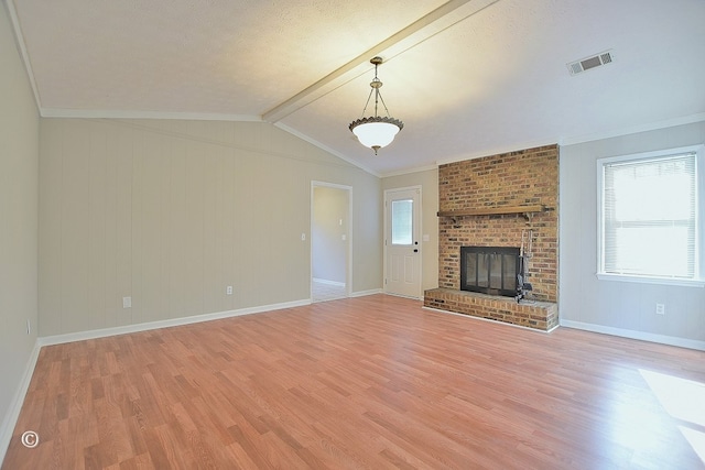 unfurnished living room featuring light wood-type flooring, visible vents, a healthy amount of sunlight, and a fireplace