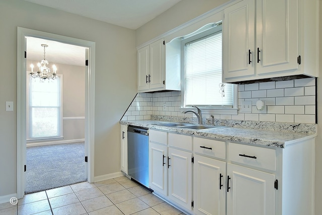 kitchen featuring a wealth of natural light, dishwasher, white cabinetry, and a sink