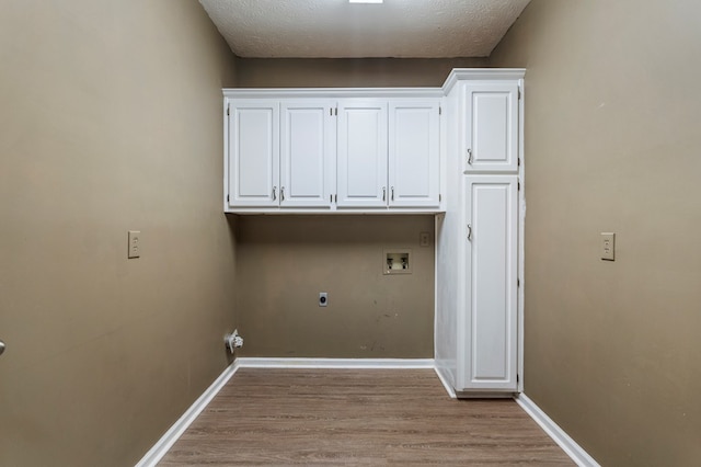 7310 Westport Loop, Midland, GA 31820 - laundry area featuring hookup for a washing machine, electric dryer hookup, light wood-style floors, a textured ceiling, and baseboards