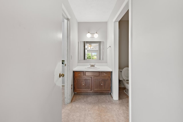 bathroom with vanity, toilet, and tile patterned floors