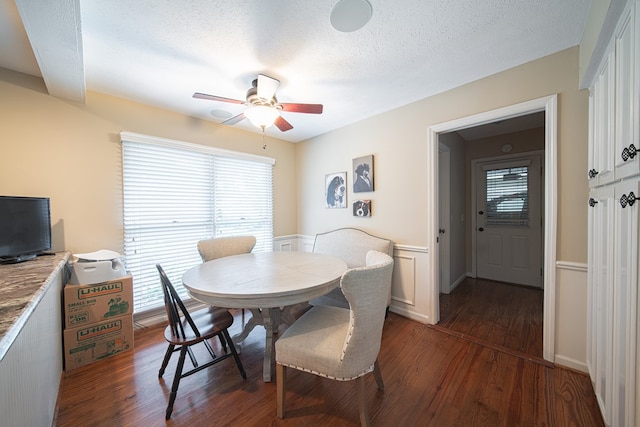 6130 Bristol Blvd, Columbus, GA 31904 - dining area featuring dark wood-style floors, ceiling fan, healthy amount of natural light, wainscoting, and a textured ceiling