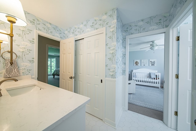 6130 Bristol Blvd, Columbus, GA 31904 - bathroom featuring wallpapered walls, vanity, tile patterned floors, a ceiling fan, and a wainscoted wall