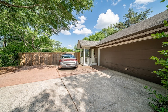 6130 Bristol Blvd, Columbus, GA 31904 - view of side of property with concrete driveway, a shingled roof, and an attached garage