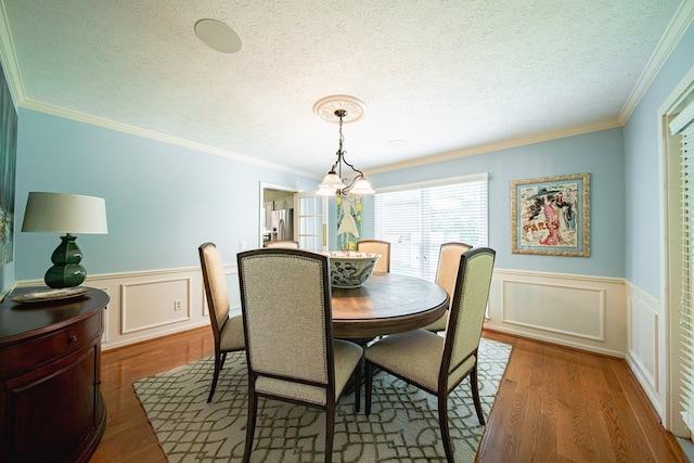 6130 Bristol Blvd, Columbus, GA 31904 - dining area with wainscoting, wood finished floors, ornamental molding, and a decorative wall