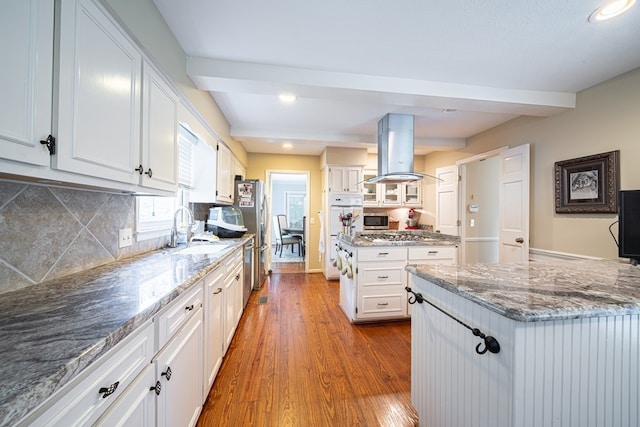 6130 Bristol Blvd, Columbus, GA 31904 - kitchen with island range hood, white cabinets, dark wood-type flooring, stainless steel appliances, and stone counters