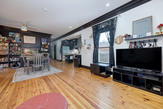 living room featuring ornamental molding, recessed lighting, baseboards, and light wood finished floors