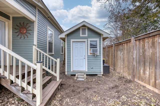 exterior space with cooling unit and fence