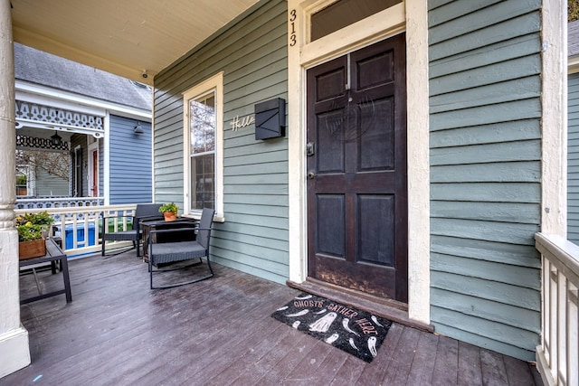 view of exterior entry featuring a porch