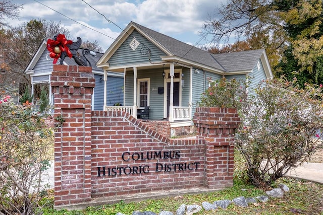 view of front facade featuring covered porch and brick siding