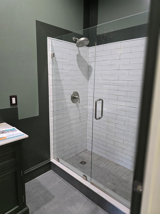 full bathroom with a shower stall, tile patterned flooring, and vanity