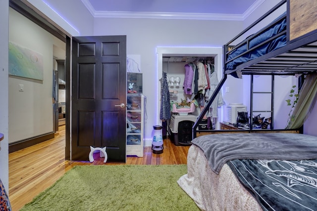 bedroom featuring ornamental molding and wood finished floors