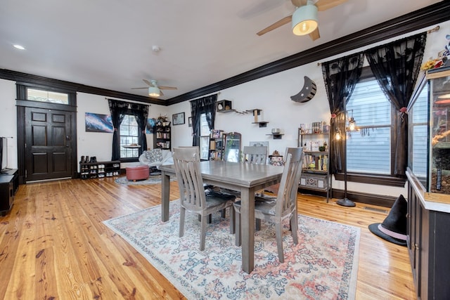 dining area with ceiling fan, crown molding, baseboards, and wood finished floors