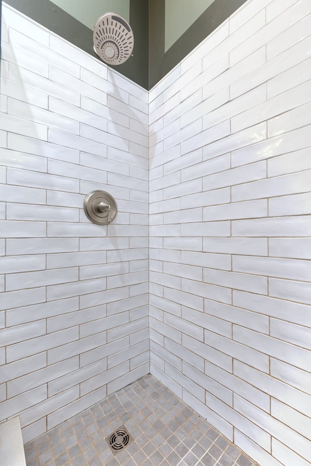 full bath with a tile shower