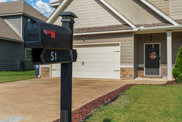 51 New Castle Dr, Phenix City, AL 36870 - view of front of house with driveway, stone siding, board and batten siding, and an attached garage