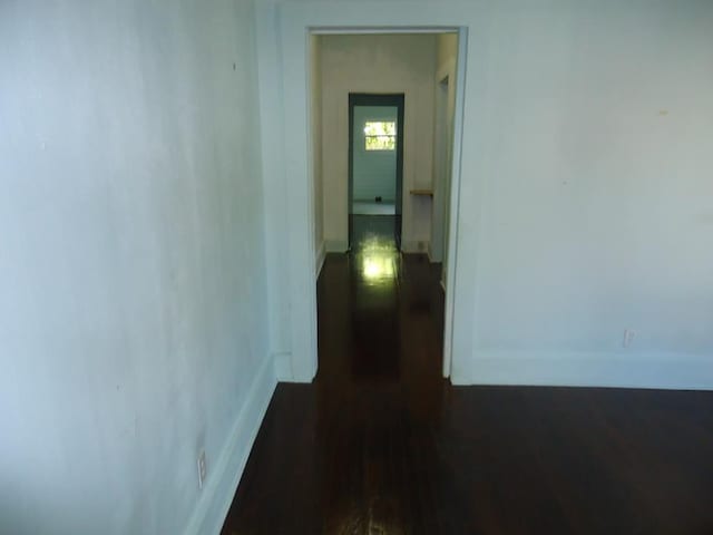 corridor featuring dark hardwood / wood-style floors