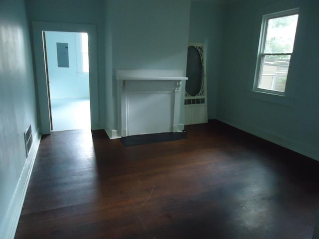 empty room with electric panel and dark wood-type flooring