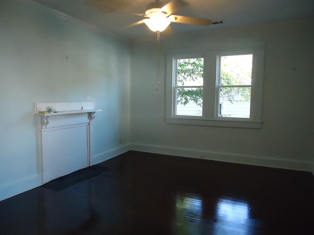 empty room with ceiling fan, hardwood / wood-style floors, and ornamental molding