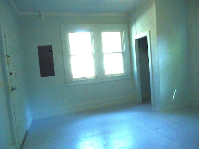 unfurnished room featuring electric panel