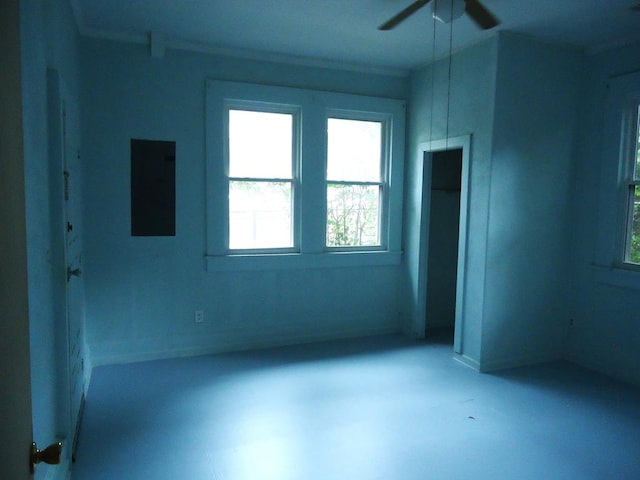 unfurnished room with concrete flooring, ceiling fan, and crown molding