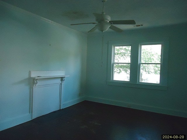 empty room with ceiling fan and ornamental molding