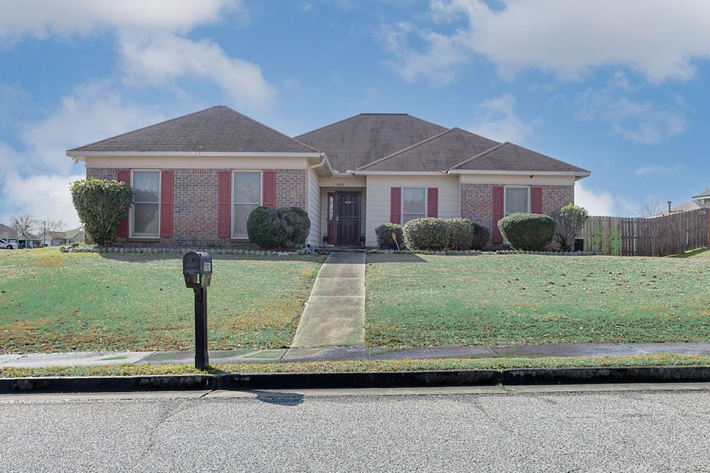 single story home featuring a front lawn