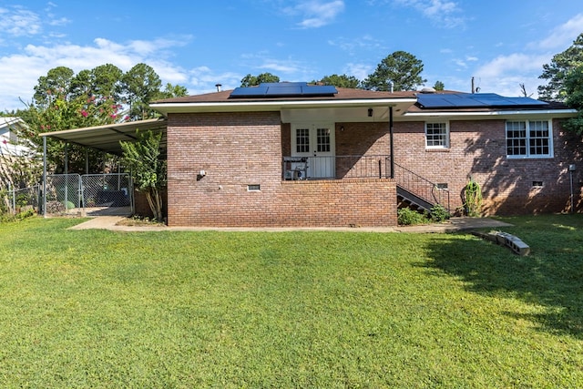 3224 Modler Dr, Columbus, GA 31909 - back of house featuring crawl space, brick siding, roof mounted solar panels, an attached carport, and a gate