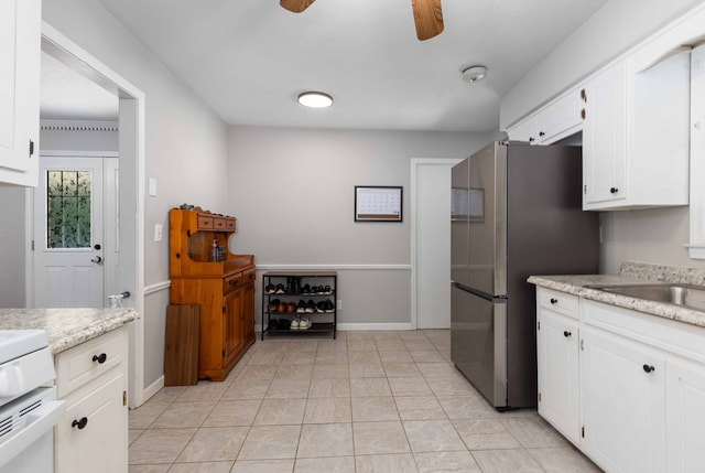 3224 Modler Dr, Columbus, GA 31909 - kitchen with a ceiling fan, freestanding refrigerator, white cabinets, and range