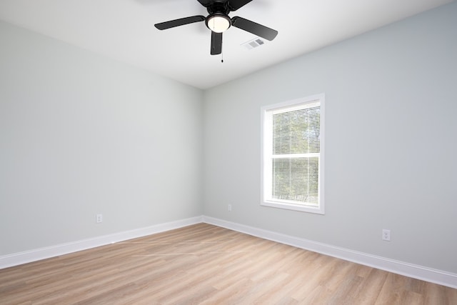 spare room with visible vents, baseboards, and light wood-style floors