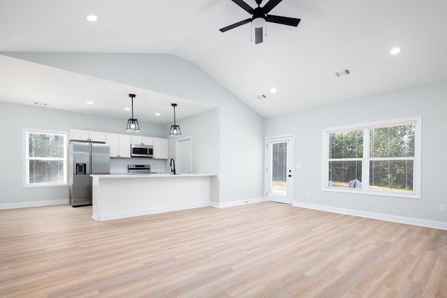 kitchen featuring open floor plan, plenty of natural light, visible vents, and appliances with stainless steel finishes