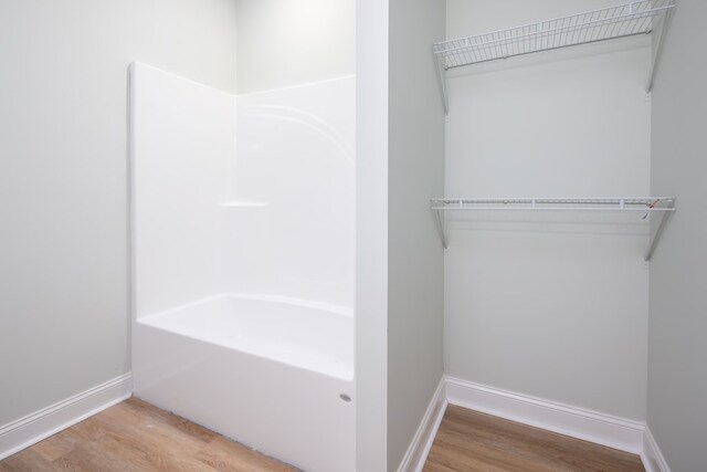 bathroom with wood finished floors and baseboards