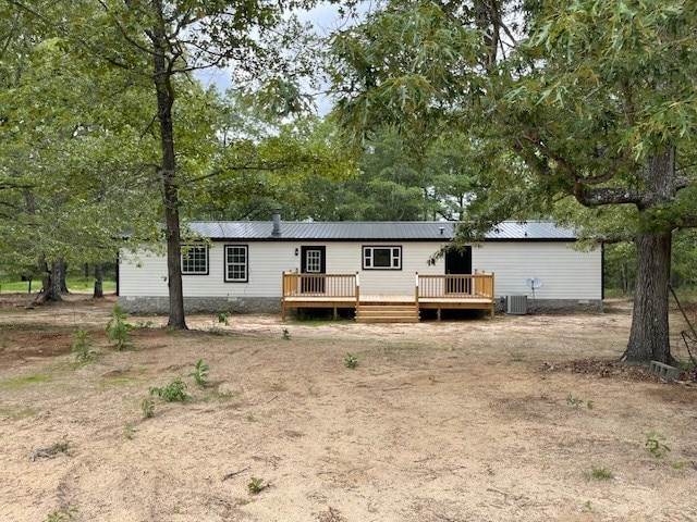 62 Brannon Montgomery Rd, Mauk, GA 31058 - rear view of house with cooling unit, a wooden deck, and metal roof
