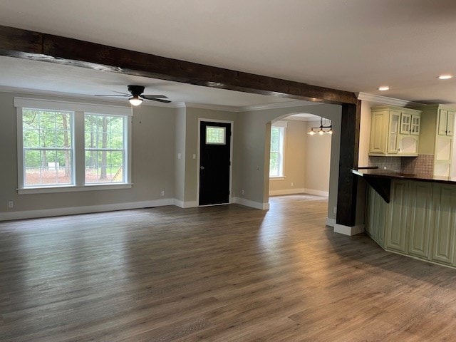 62 Brannon Montgomery Rd, Mauk, GA 31058 - unfurnished living room featuring arched walkways, baseboards, recessed lighting, and wood finished floors