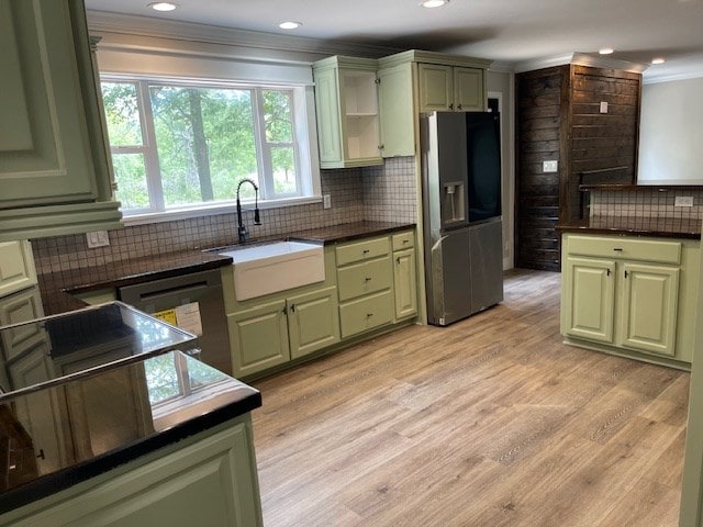 62 Brannon Montgomery Rd, Mauk, GA 31058 - kitchen with decorative backsplash, stainless steel fridge, green cabinetry, a sink, and dishwasher