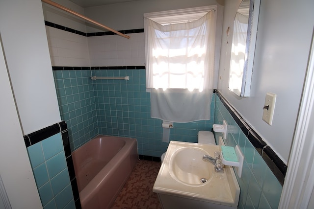 bathroom featuring tile walls, vanity, tile patterned floors, and tub / shower combination