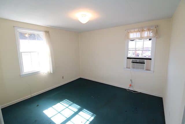 unfurnished room featuring cooling unit and concrete floors