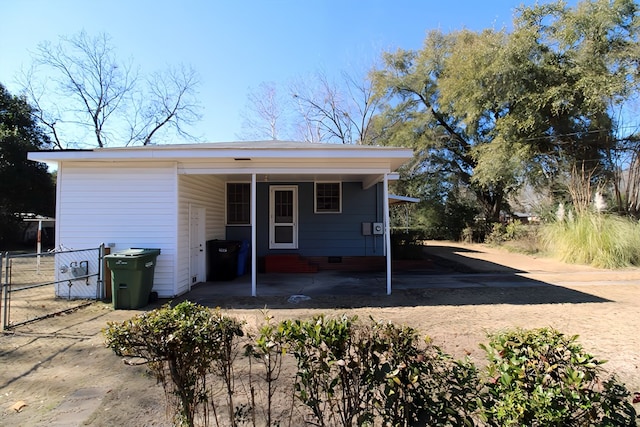 rear view of property with a carport