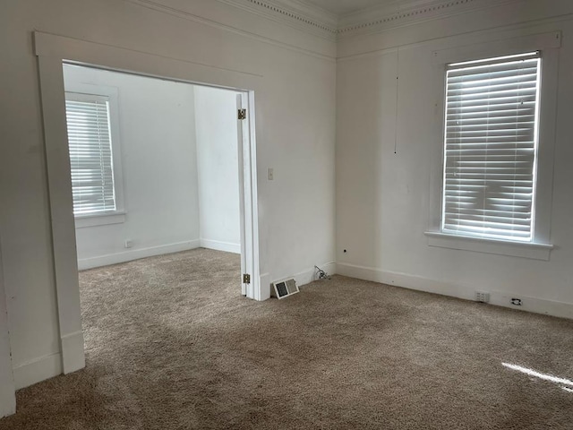 carpeted spare room with crown molding