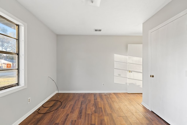 unfurnished room featuring dark hardwood / wood-style flooring